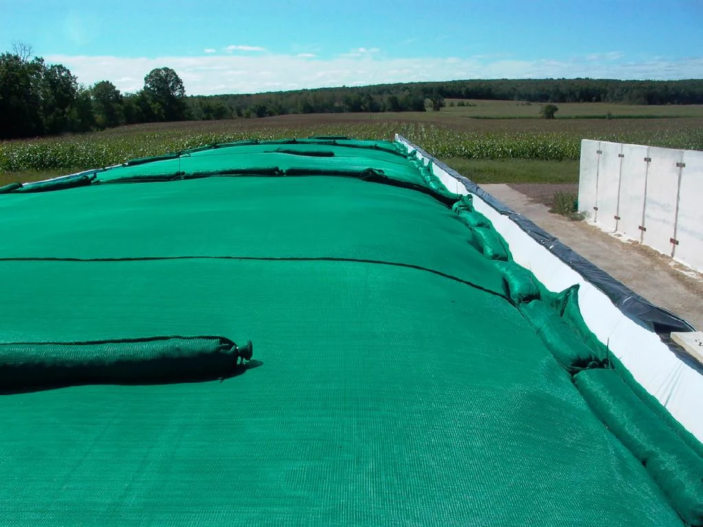 Silage covering net secured with gravel bags