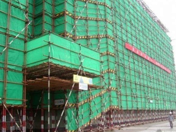 Debris netting installed on building scaffolding